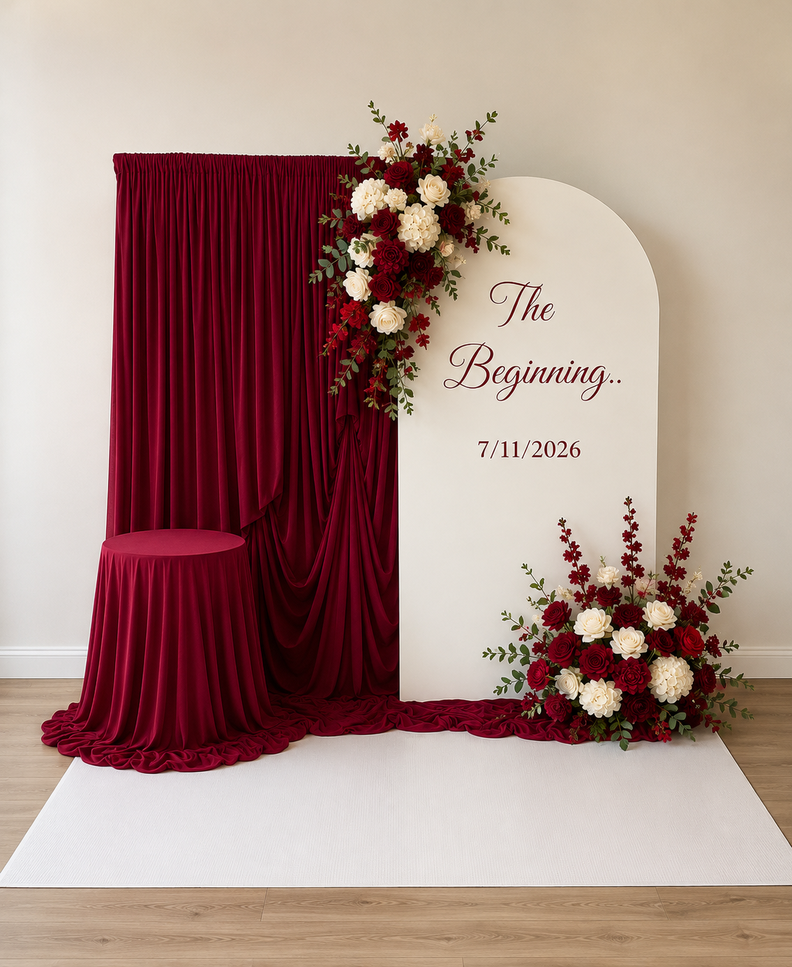 Burgundy draping beside a cream arch with floral arrangements
