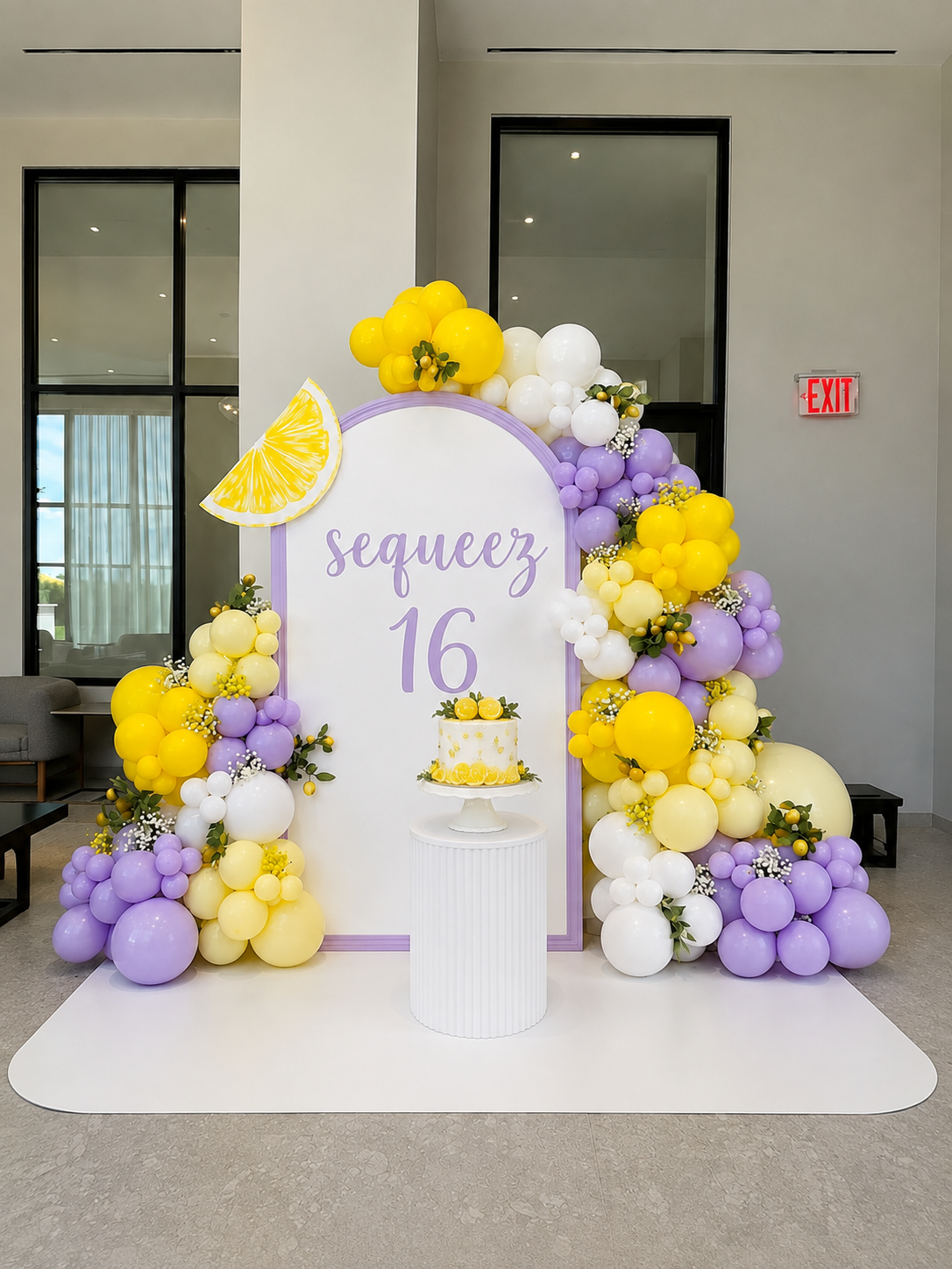 Lavender birthday backdrop with yellow and lavender balloons and a sweet sixteen message