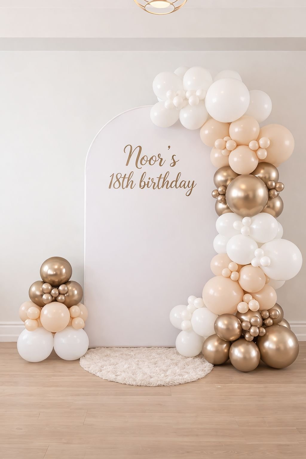 White and gold balloons framing a personalized eighteenth birthday backdrop
