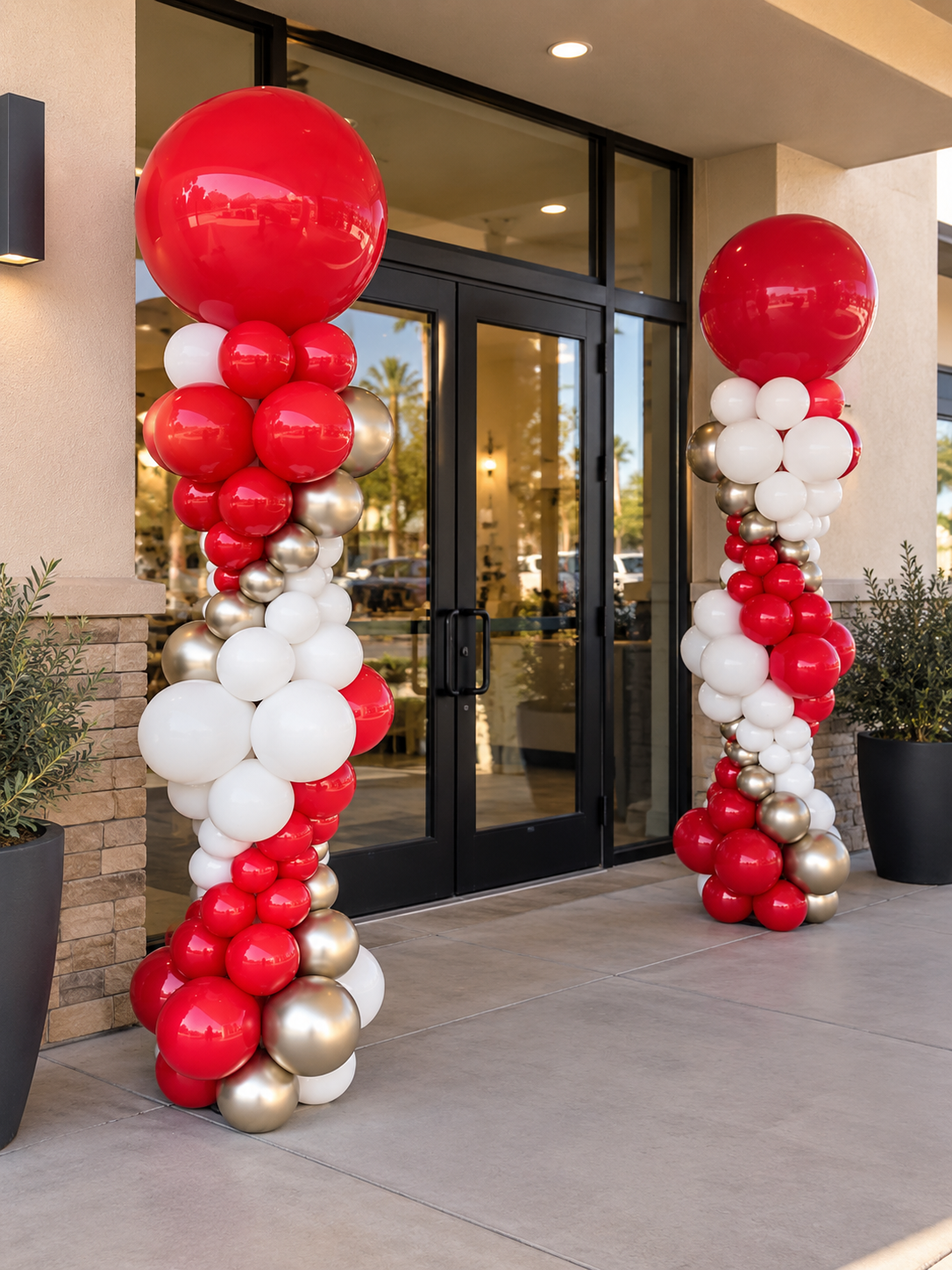 Red and white balloon columns at a grand opening